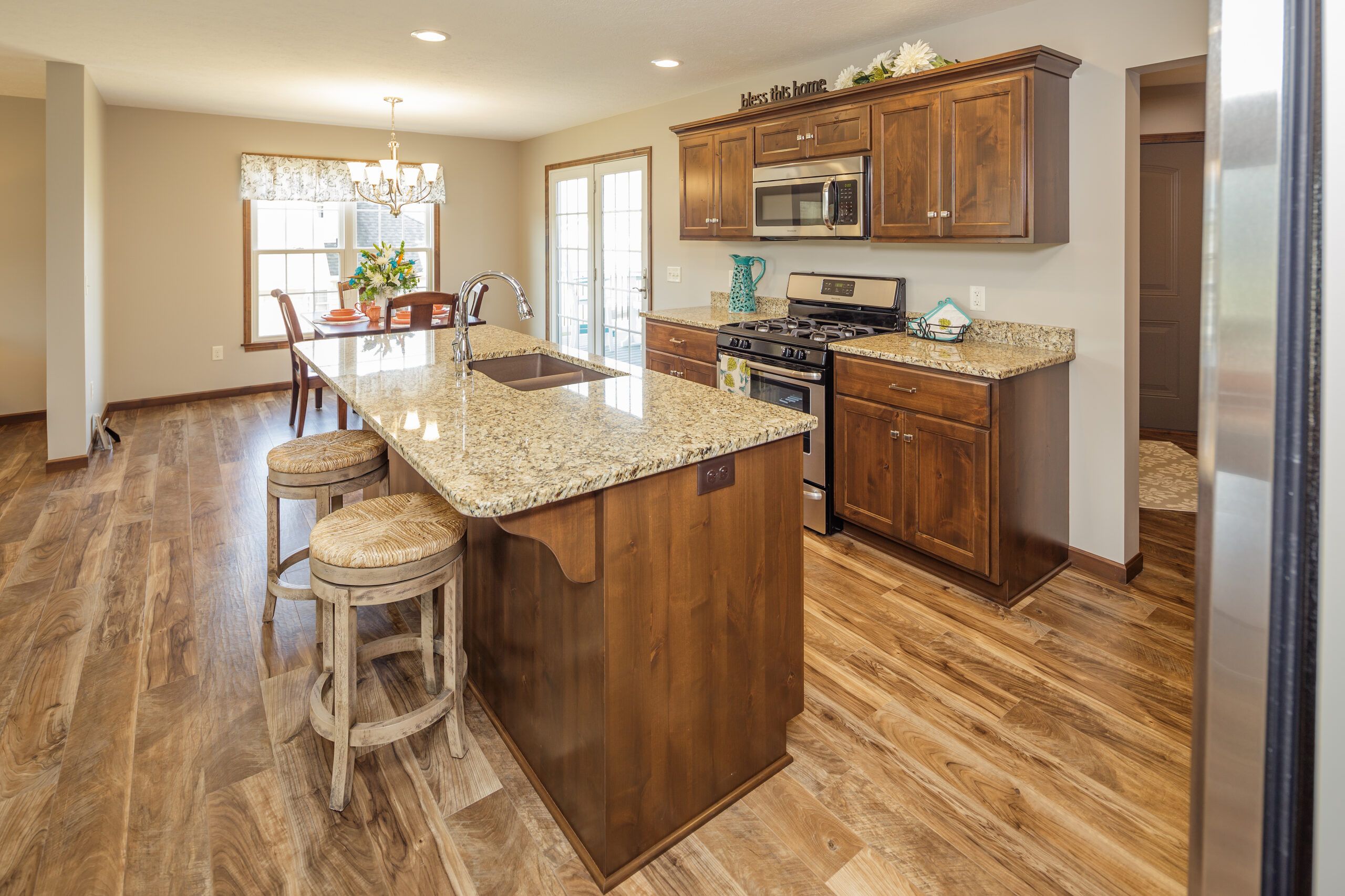 Cozy custom design kitchen with island and bar stools for casual dining and family time