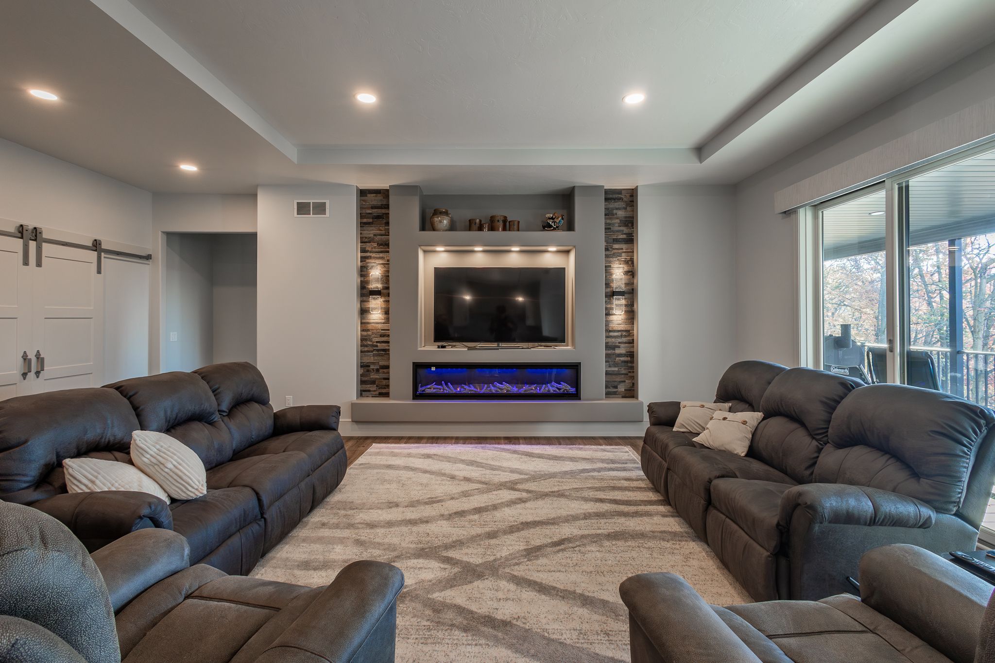 Spacious living area with lounging furniture and fireplace