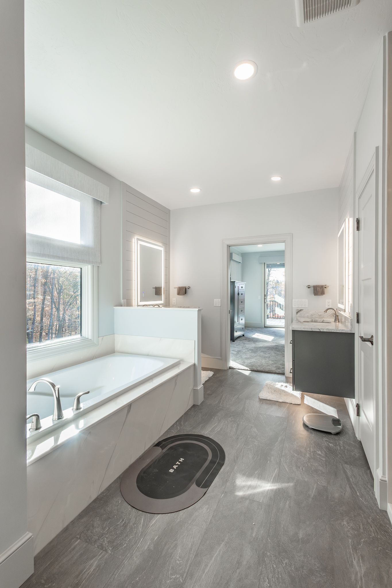 Modern bathroom with jacuzzi and lighted mirror